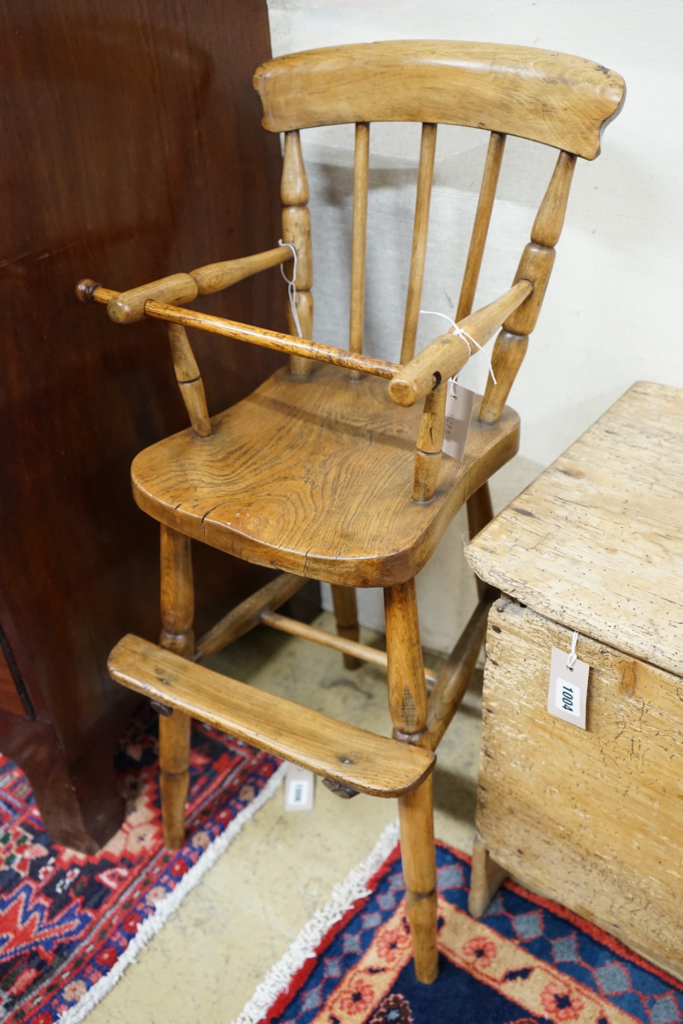A Victorian elm and beech Windsor comb back child's high chair, height 84cm